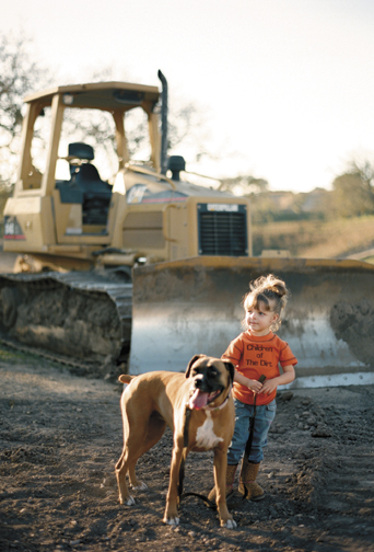 Two-and-a-half-year-old Savana Guglielmo with the family boxer, Trixie.